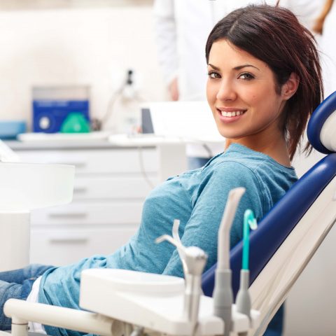 Young female patient sitting on chair in dental office.preparing